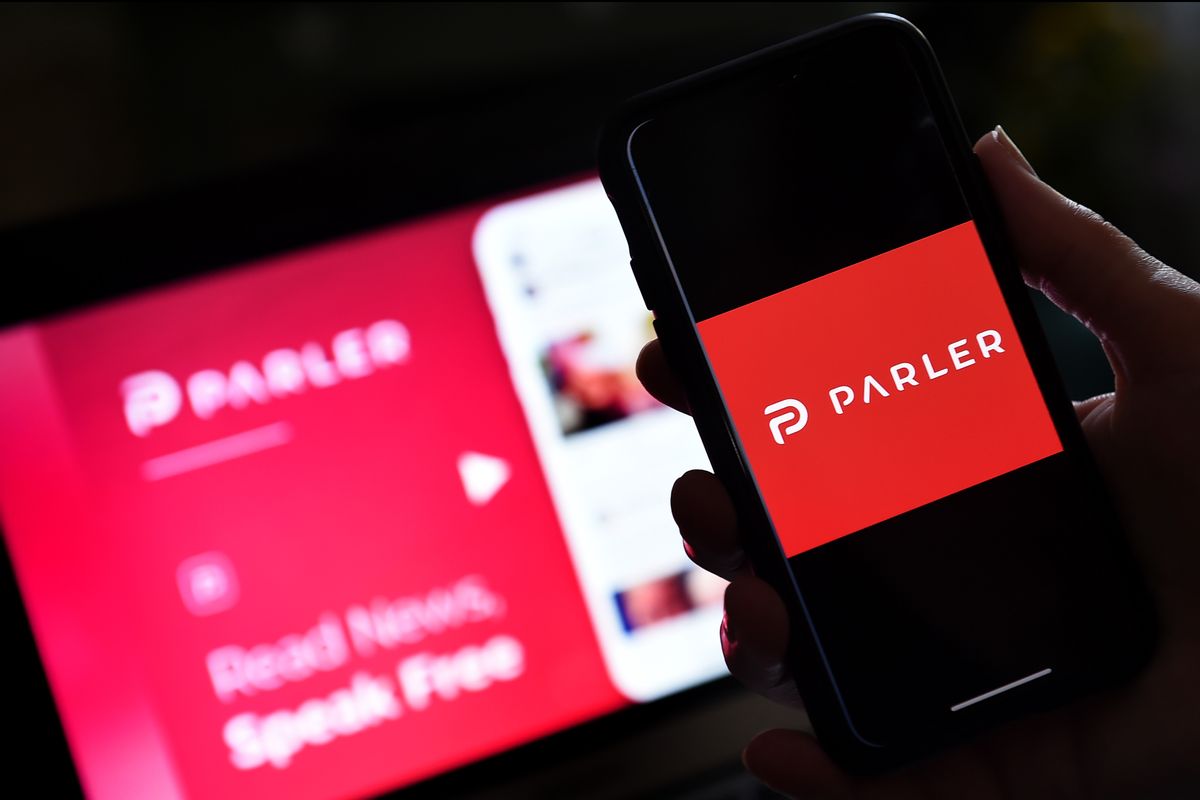 This illustration picture shows social media application logo from Parler displayed on a smartphone with its website in the background. Parler, founded in Nevada in 2018, bills itself as an alternative to "ideological suppression" at other social networks. (OLIVIER DOULIERY/AFP via Getty Images)