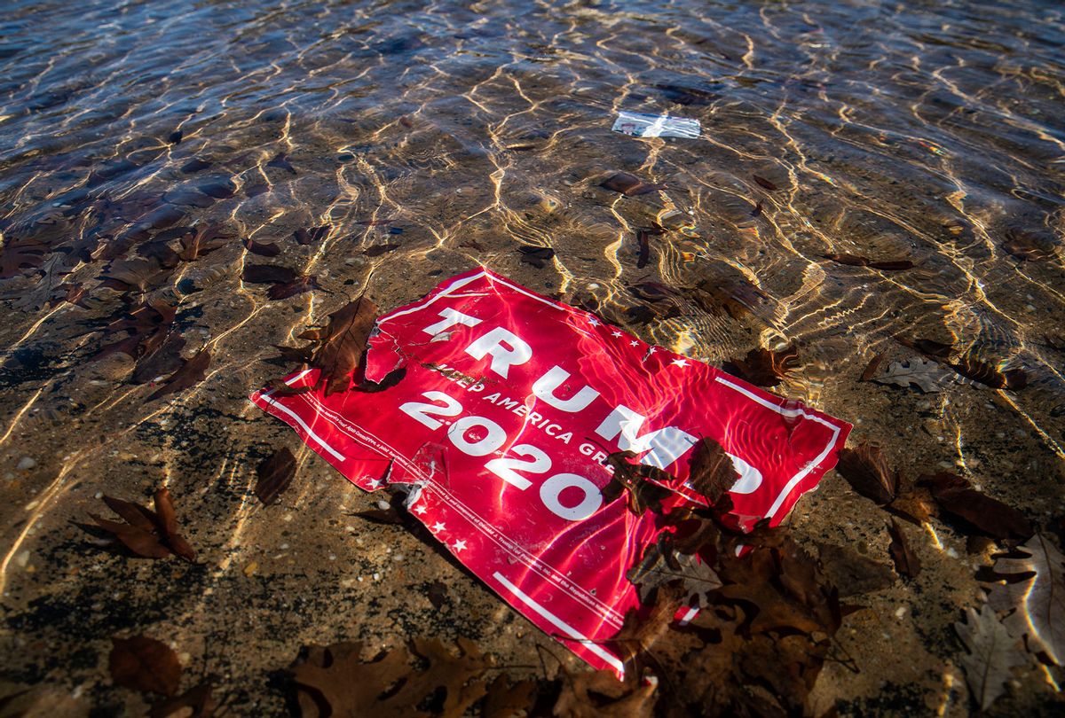 A campaign sign for U.S. President Donald Trump lies beneath the water in the Capitol Reflecting Pool, near the West Front of the U.S. Capitol on January 9, 2021 in Washington, DC. (Al Drago/Getty Images)