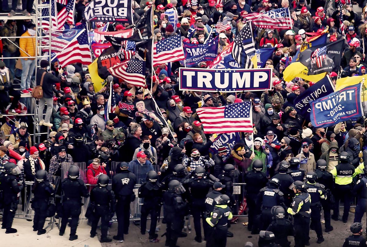 Police hold back supporters of US President Donald Trump as they gather outside the US Capitol's Rotunda on January 6, 2021, in Washington, DC. - Demonstrators breeched security and entered the Capitol as Congress debated the a 2020 presidential election Electoral Vote Certification. (OLIVIER DOULIERY/AFP via Getty Images)