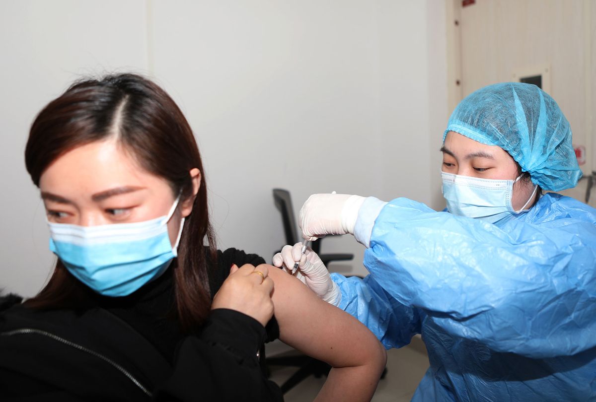 A medical worker inoculates a citizen with Covid-19 vaccine at a children's hospital in Chongqing, China, Feb. 16, 2021. (Costfoto/Barcroft Media via Getty Images)