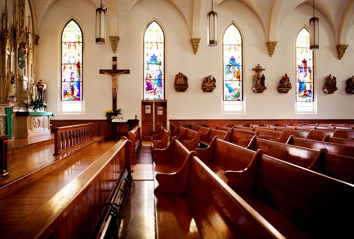 Empty pews and stained glass windows in church (Getty Images)