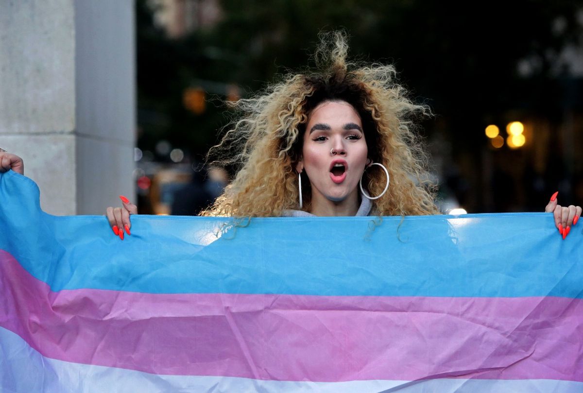 Morgin Dupont holds up the flag for Transgender and Gender Noncomforming people at a rally for LGBTQI+ rights  (Yana Paskova/Getty Images)