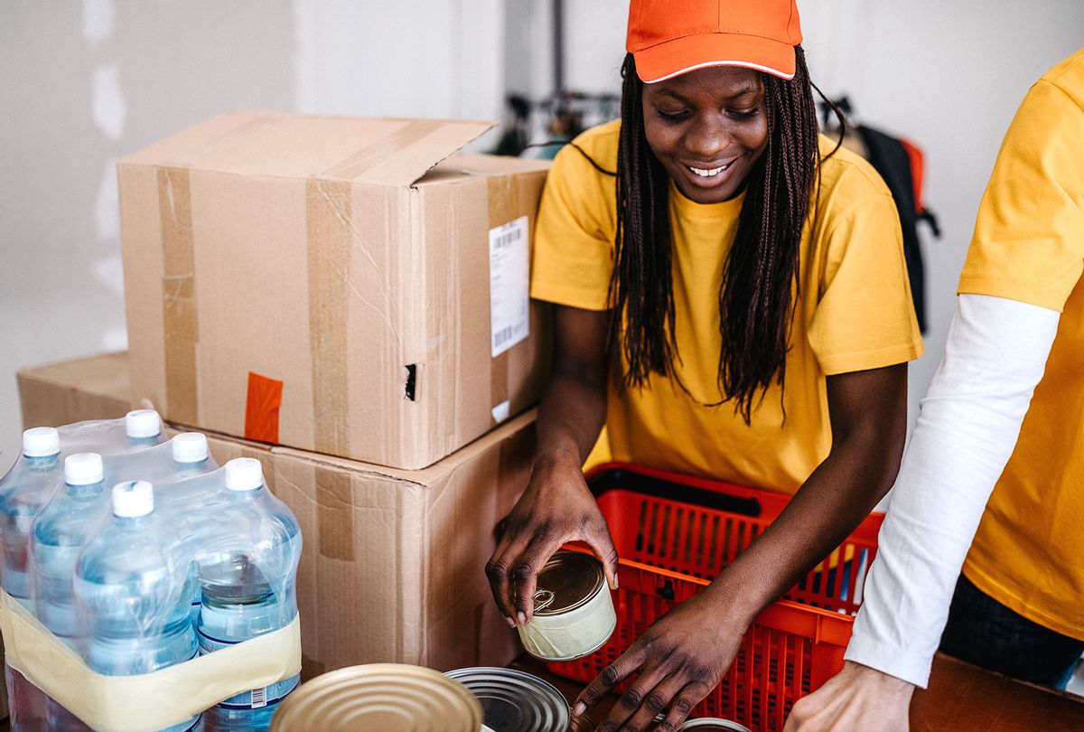 Young woman sorting donations (Getty Images)