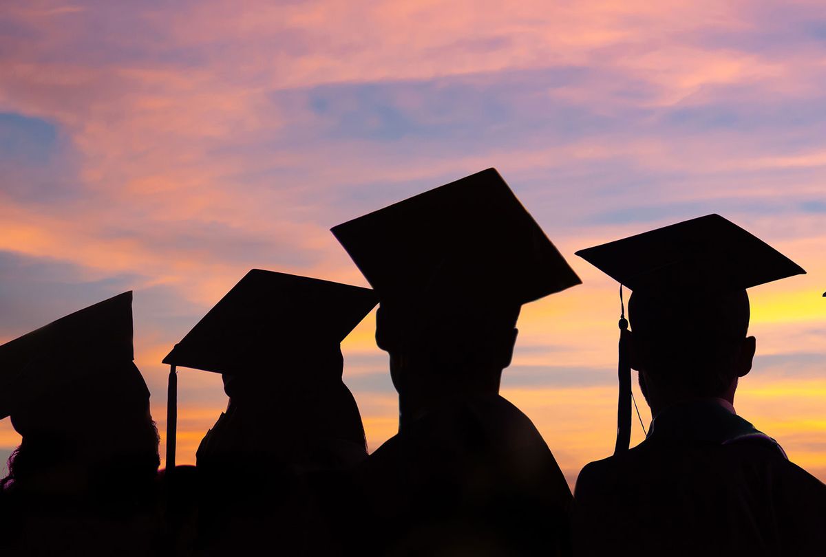 Silhouettes of students with graduate caps in a row on sunset background (Getty Images)