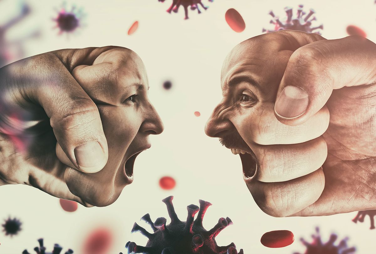 Two fists with man's and woman's face are collide with each other on coronavirus background (Getty Images)