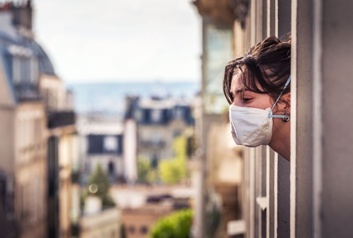A Parisian girl looks outside the window during the quarantine because the containment of the virus is essential. (Getty Images)