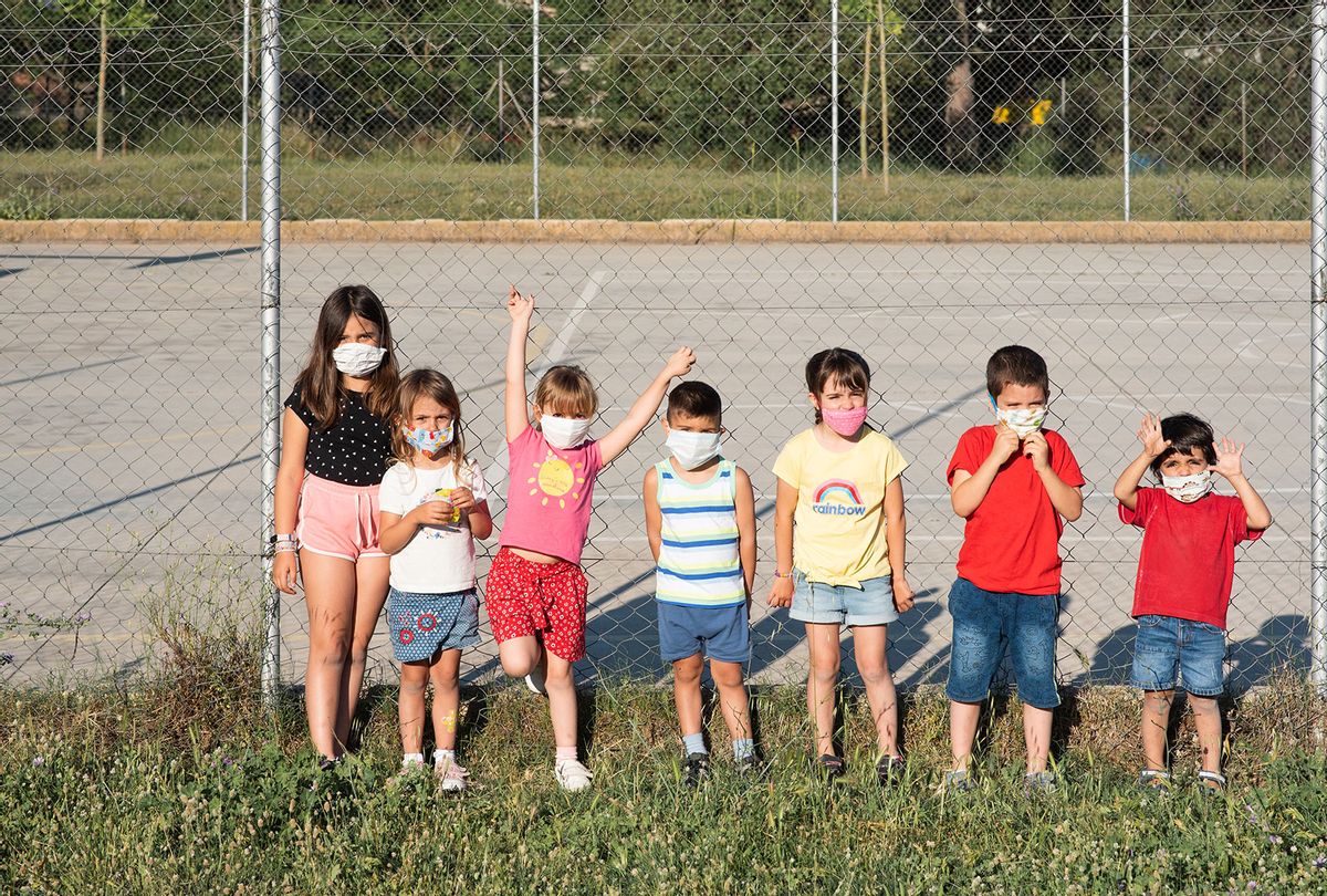 Children playing in the park in face masks (Getty Images)
