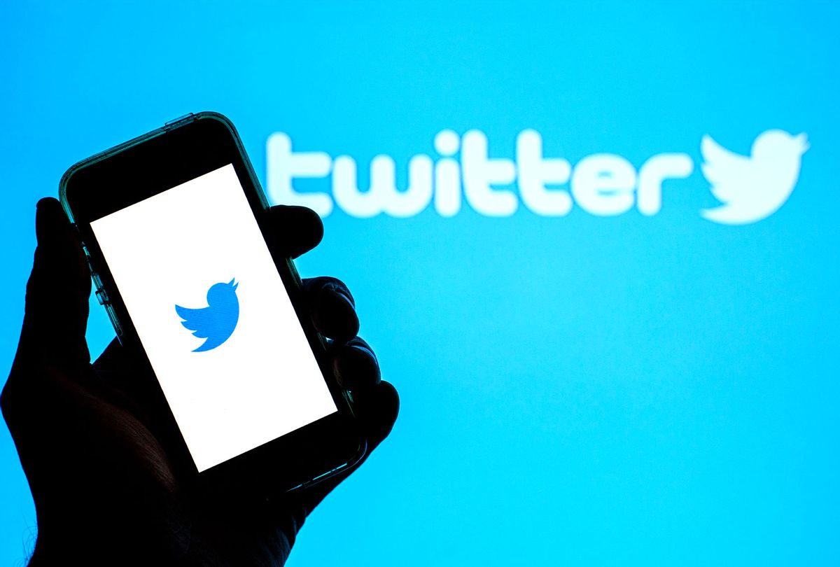 Twitter app seen displayed on a smartphone with the Twitter logo in the background (Illustration by Thiago Prudêncio/SOPA Images/LightRocket via Getty Images)
