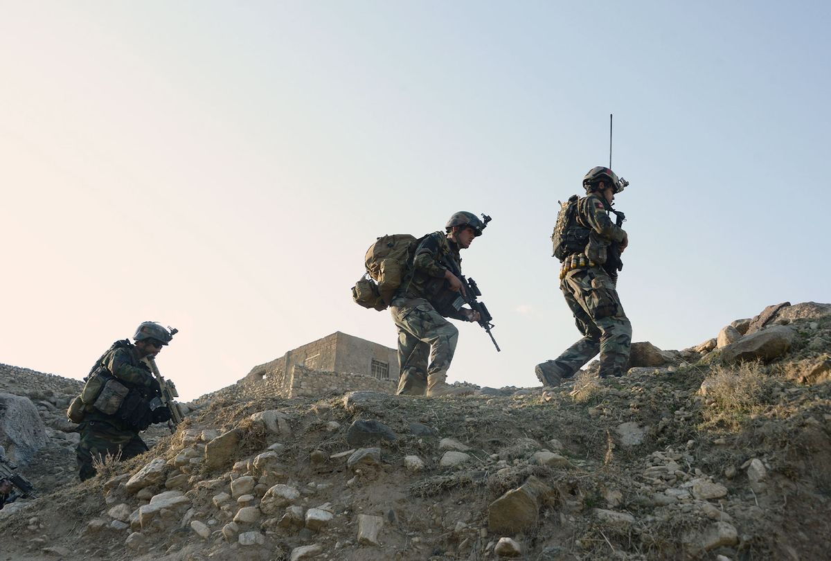 In this photograph taken on January 3, 2018, Afghan commandos forces patrol during ongoing US-Afghan military operation against Islamic State militants in Achin district of Nangarhar province. Afghan security forces are conducting most of the fighting against the Taliban and other insurgent groups as US troops operate alongside them in a training capacity and are frequently on the front lines. (NOORULLAH SHIRZADA/AFP via Getty Images)