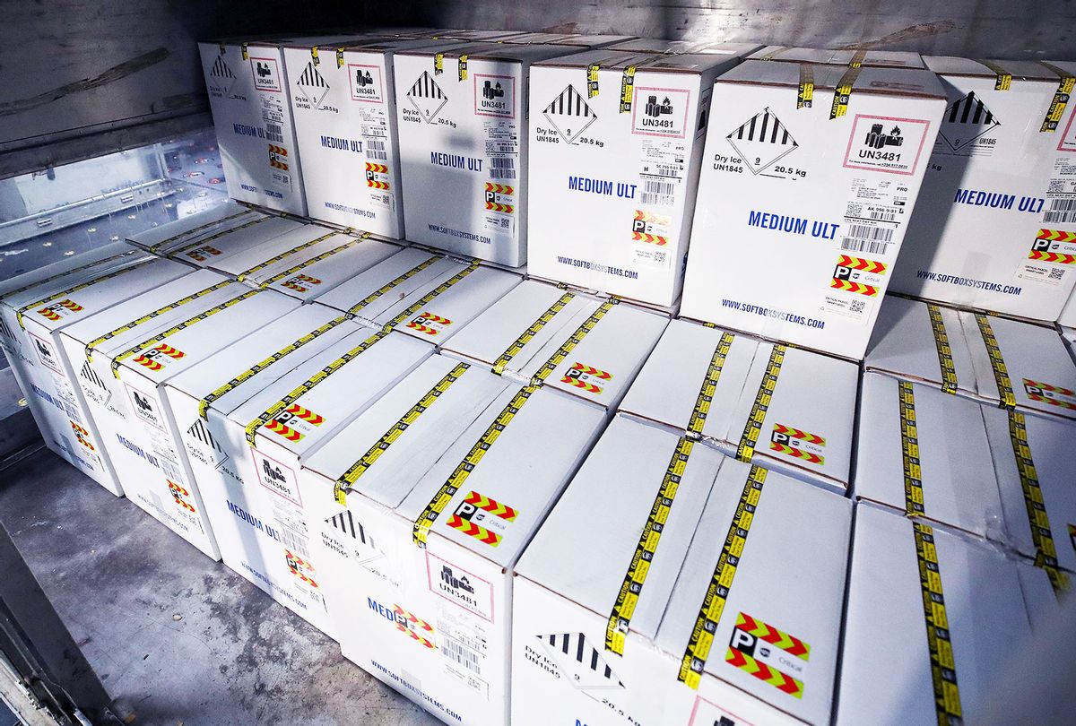 Boxes containing the first shipments of the Pfizer and BioNTech COVID-19 vaccine are unloaded from air shipping containers at UPS Worldport in Louisville, Kentucky. Each box contains dry ice to keep the temperature at minus 70 Celsius and contains a GPS tracker. (Michael Clevenger - Pool/Getty Images)