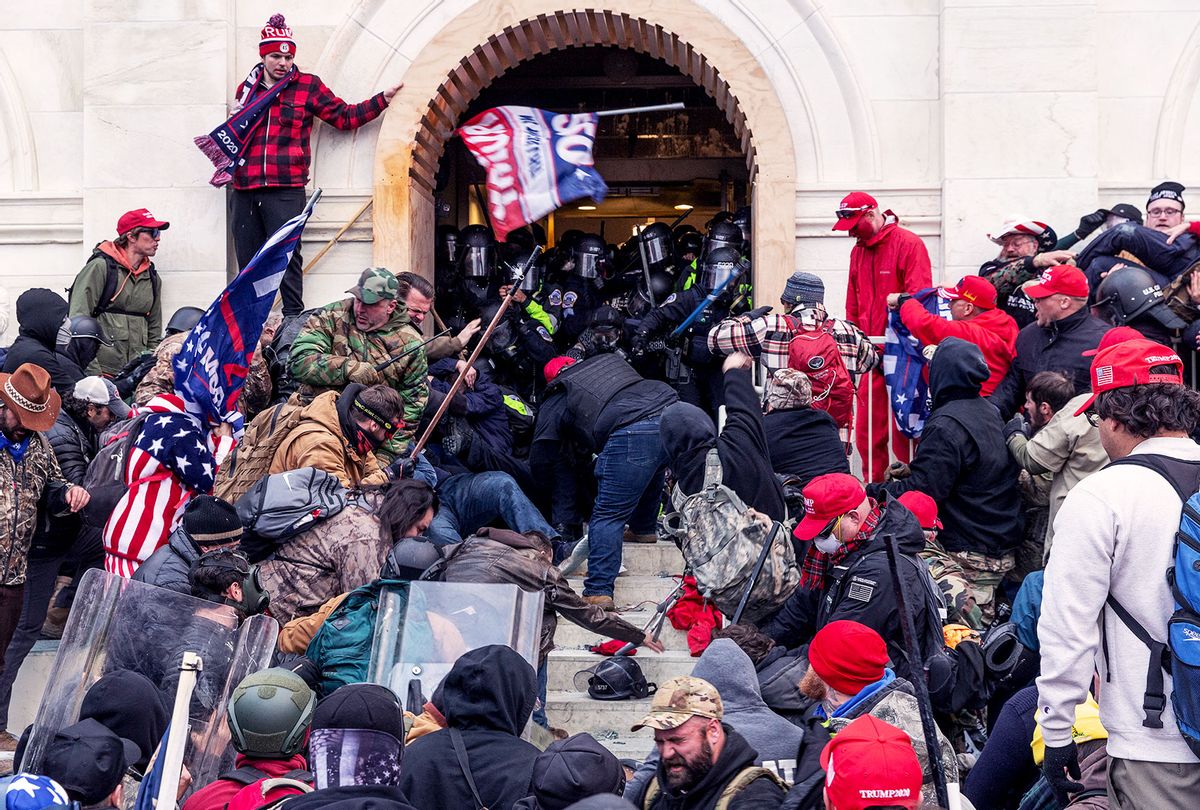 Rioters clash with police trying to enter Capitol building through the front doors. Rioters broke windows and breached the Capitol building in an attempt to overthrow the results of the 2020 election. (Lev Radin/Pacific Press/LightRocket via Getty Images)