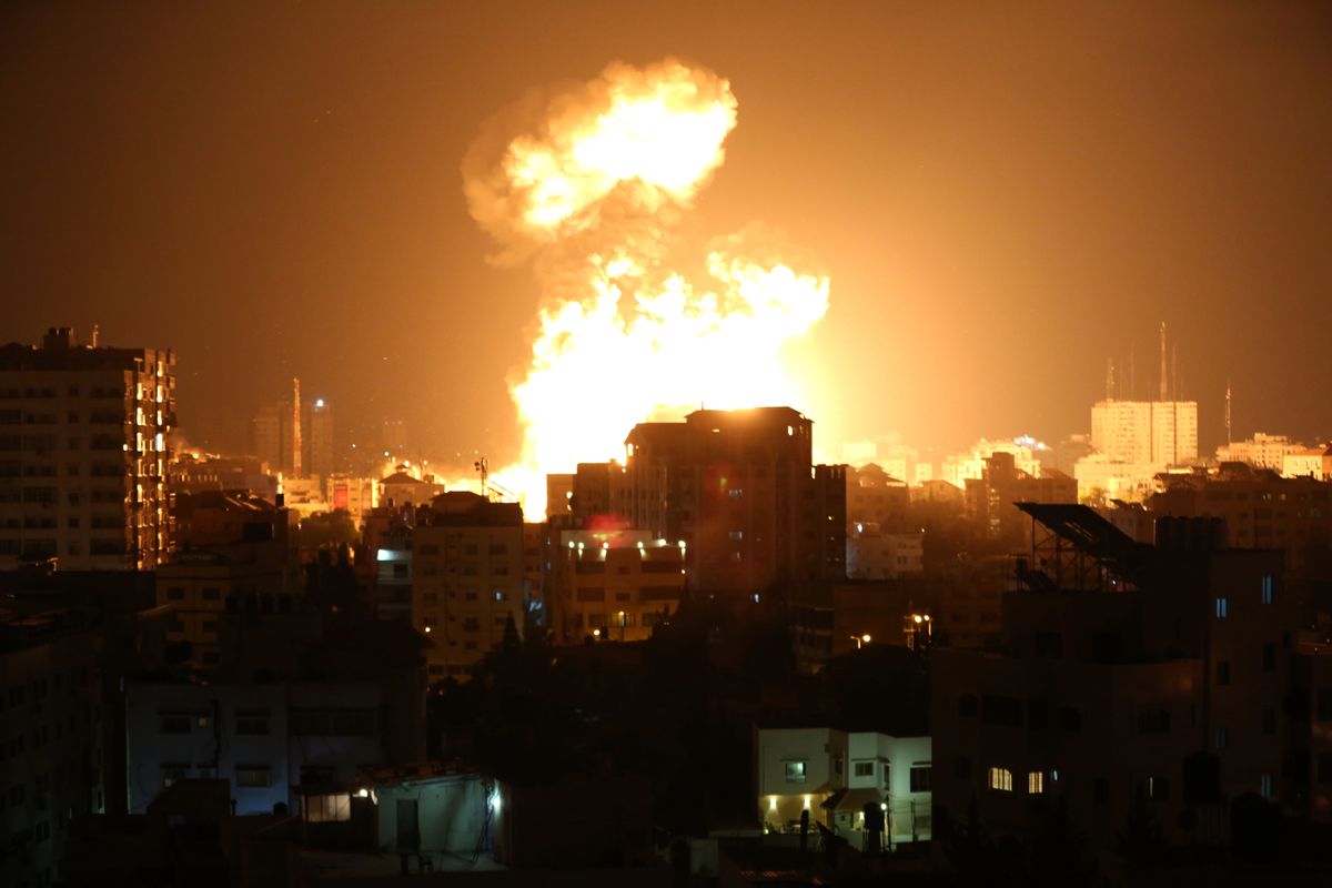 Smoke and flames rise after Israeli fighter jets conducted airstrikes in Gaza City, Gaza on May 13, 2021. (Ashraf Amra/Anadolu Agency via Getty Images)