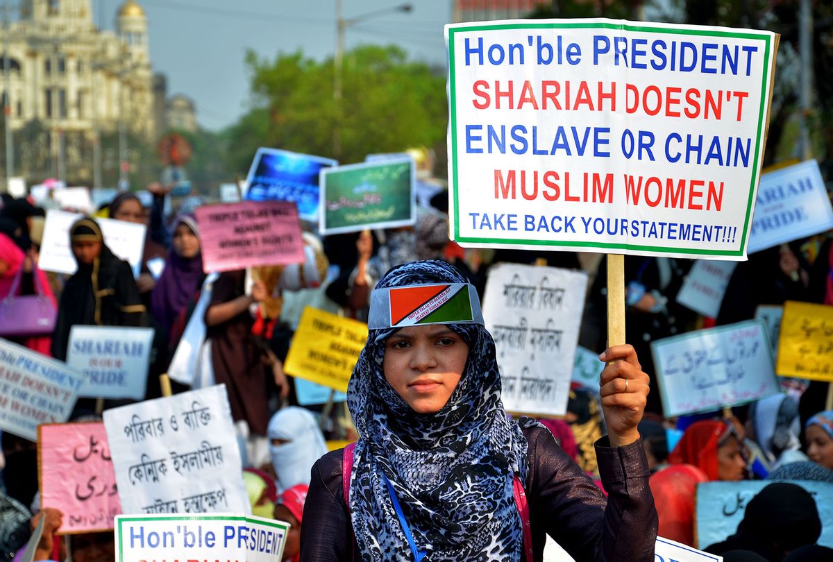 Indian Muslim women hold placards and take part in a silent protest rally to demand a repeal of the "triple talaq" or instant divorce bill  (Sanjay Purkait/Pacific Press/LightRocket via Getty Images)