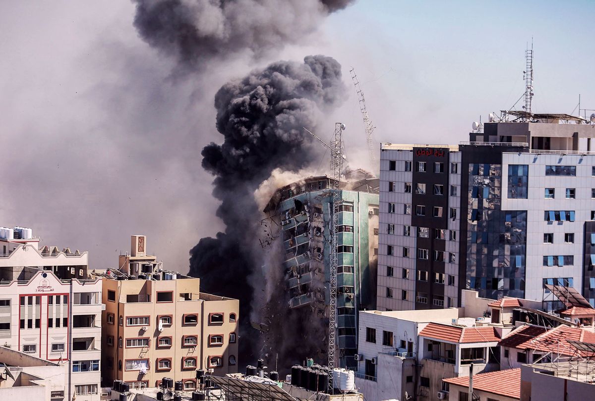 Smoke rise after an Israeli air-strike hits at Al-Jalaa tower, which houses apartments and several media outlets, including The Associated Press and Al Jazeera, amid the escalating flare-up of Israeli-Palestinian violence. (Mohammed Talatene/picture alliance via Getty Images)