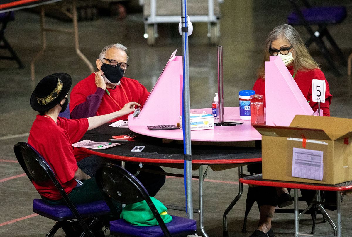 Contractors working for Cyber Ninjas, who was hired by the Arizona State Senate, examine and recount ballots from the 2020 general election at Veterans Memorial Coliseum on May 1, 2021 in Phoenix, Arizona. The Maricopa County ballot recount comes after two election audits found no evidence of widespread fraud. (Courtney Pedroza/Getty Images)