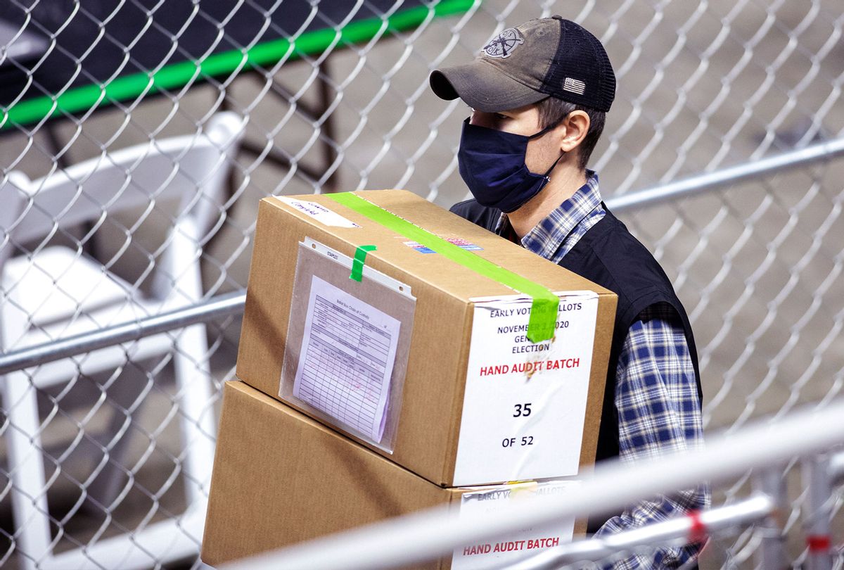 A contractor working for Cyber Ninjas, who was hired by the Arizona State Senate transports ballots from the 2020 general election at Veterans Memorial Coliseum on May 1, 2021 in Phoenix, Arizona. The Maricopa County ballot recount comes after two election audits found no evidence of widespread fraud in Arizona. (Courtney Pedroza/Getty Images)