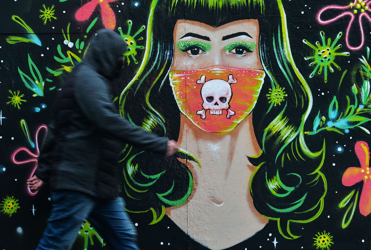 A man walks past a mural by Mr. Gabriel Marques in Dublin (Artur Widak/NurPhoto via Getty Images)