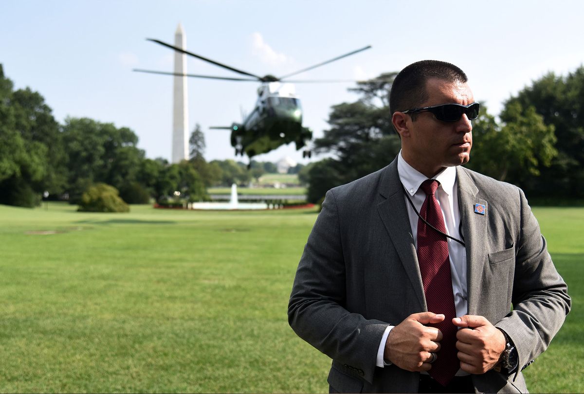 A Secret Service agent stands guard as Marine One with US President Donald Trump on board, lands at the White House on July 21, 2019, in Washington, DC. (OLIVIER DOULIERY/AFP via Getty Images)