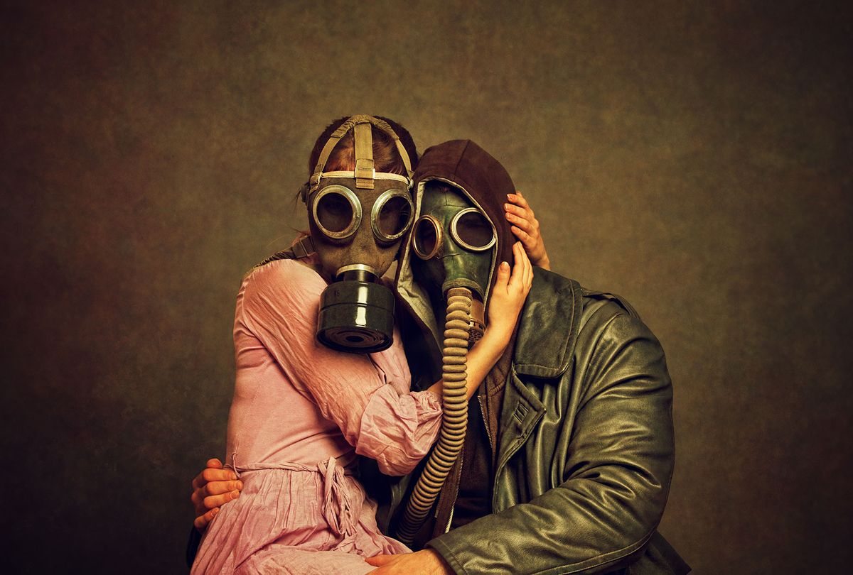 Couple in gas masks embracing (Getty images)