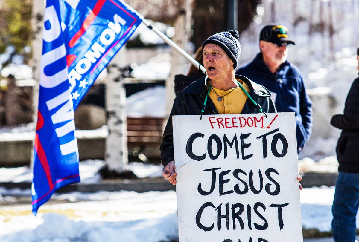 A protestor holds a placard during the demonstration. Protesters gathered at the state's legislative building to protest various causes such as the Biden inauguration, Covid-19 restriction, vaccine, religious ideas, Qanon, common core education, without a cohesive message, during the first day of the 81st (2021) Session of the Nevada Legislature. (Ty O'Neil/SOPA Images/LightRocket via Getty Images)