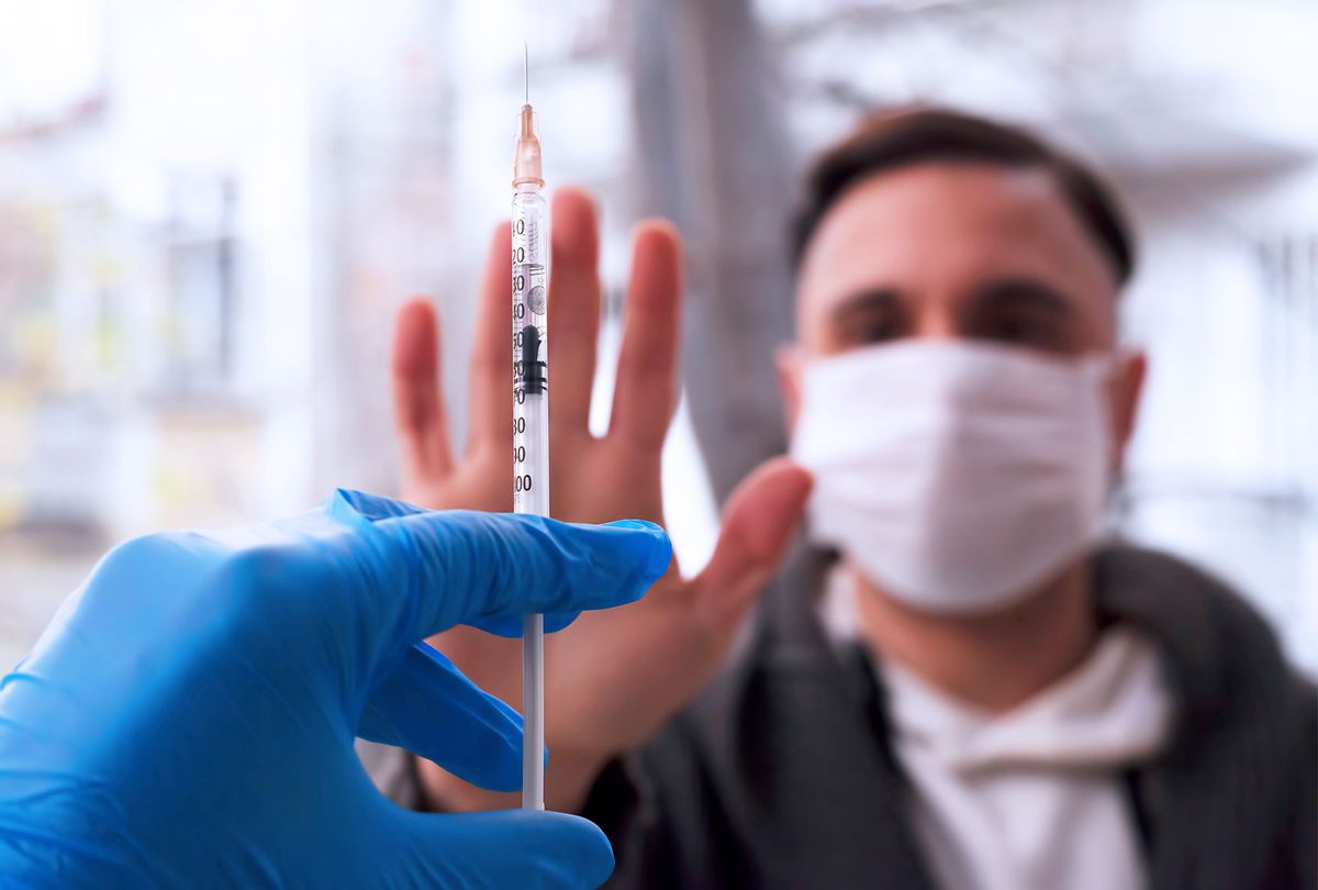 Man refusing to get injection of vaccine (Getty Images)