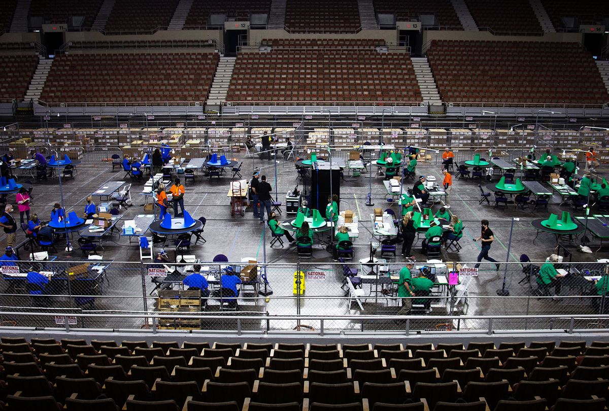 Contractors working for Cyber Ninjas, who was hired by the Arizona State Senate, examine and recount ballots from the 2020 general election at Veterans Memorial Coliseum on May 8, 2021 in Phoenix, Arizona. (Courtney Pedroza for the Washington Post)