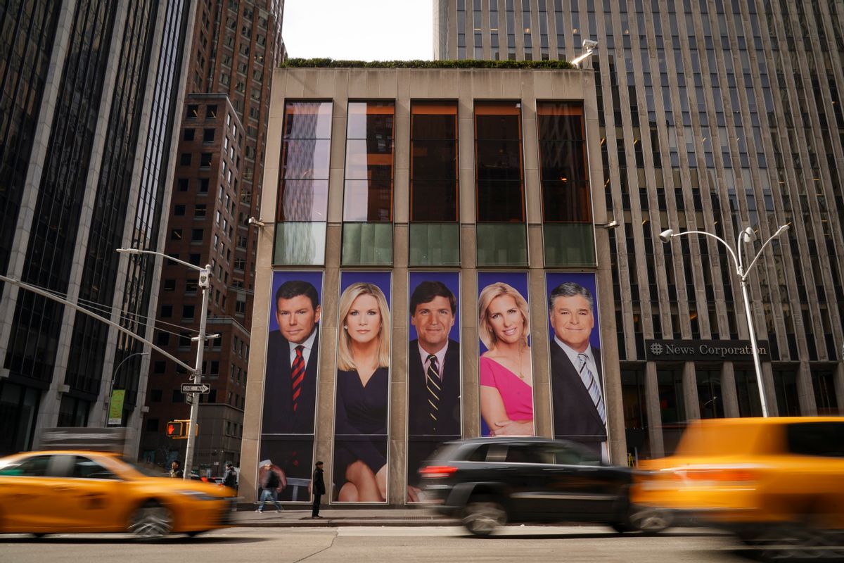 Tucker Carlson and Sean Hannity's images displayed on the side of the Fox News building in midtown Manhattan. (Getty Images)