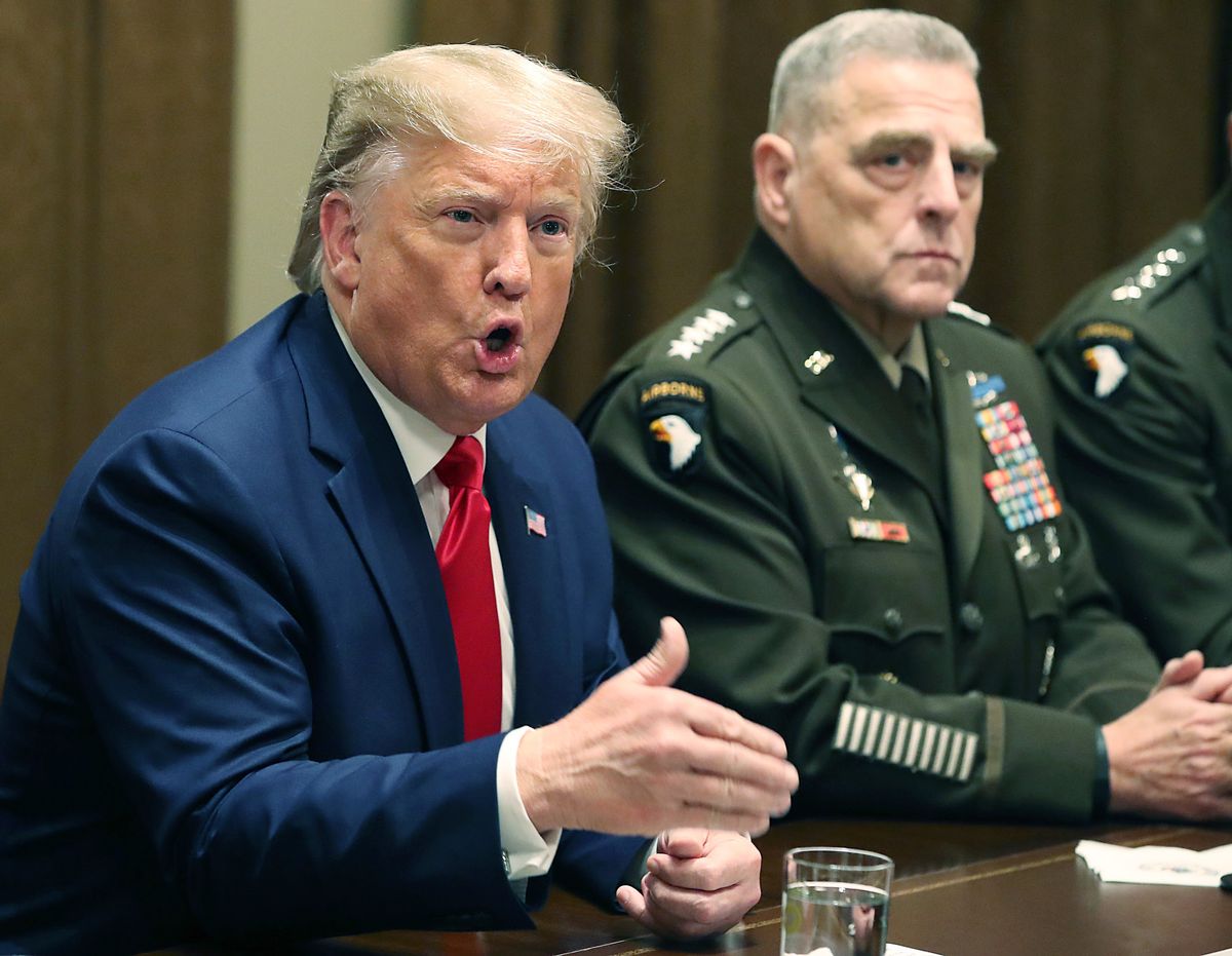 Former President Donald Trump speaks as Joint Chiefs of Staff Chairman, Army General Mark Milley, looks on. (Mark Wilson/Getty Images)