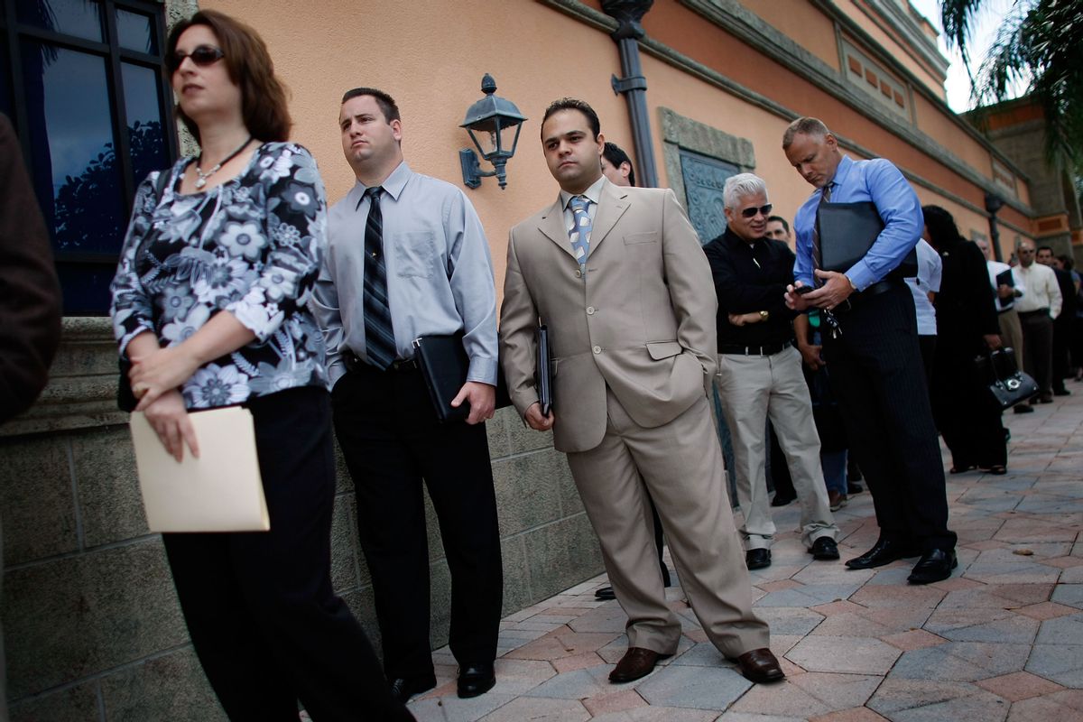 Dawn Dennan, left, Steven Oster, center, and Samer Eleid stand in line with hundreds of other job seekers as they look for jobs at the South Florida Diversity Job Expo in Davie, Florida. (Getty Images)