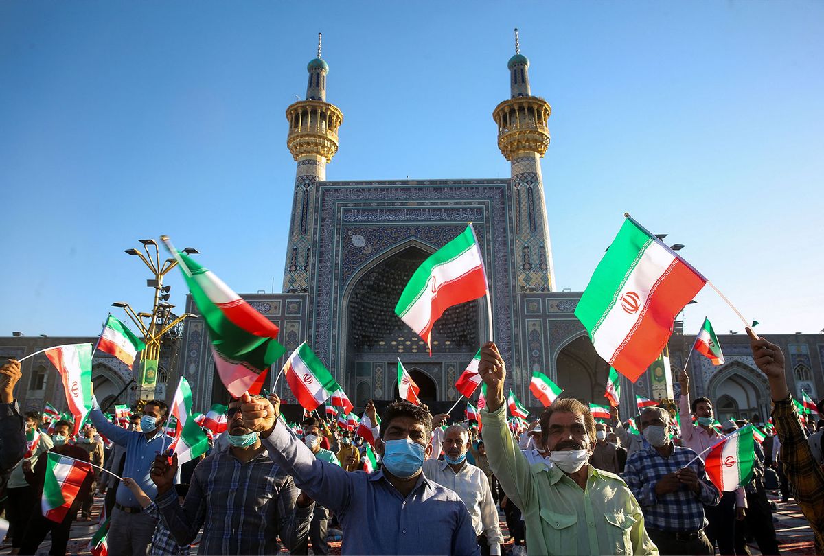 Supporters of Iran's President-elect Ebrahim Raisi cheer at the Imam Reza shrine in the city of Mashhad in northeastern Iran, on June 22, 2021. - On June 19 the 60-year-old was named the winner of the Islamic republic's presidential election, set to take over from moderate Hassan Rouhani in August. (MOHSEN ESMAEILZADEH/ISNA NEWS AGENCY/AFP via Getty Images)