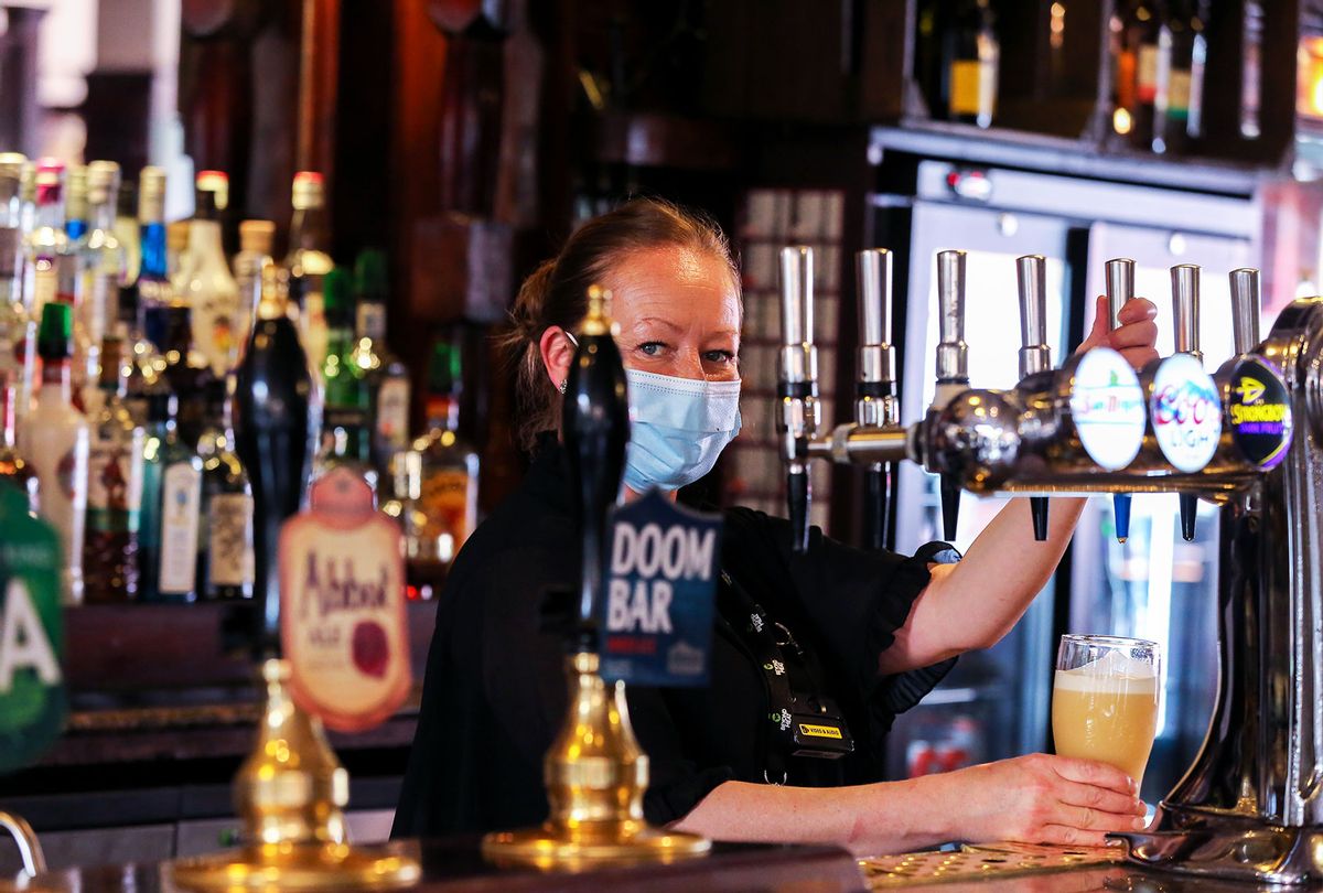 A barmaid prepares beer for a customer in a Pub (Dinendra Haria/SOPA Images/LightRocket via Getty Images)