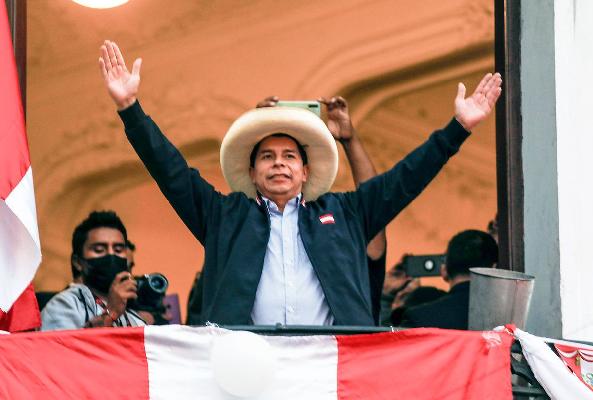 Presidential candidate Pedro Castillo of Peru Libre waves supporters at his political party's headquarters balcony after a tight runoff against presidential candidate for Fuerza Popular Keiko Fujimori on June 7, 2021 in Lima, Peru. (Ricardo Moreira/Getty Images)