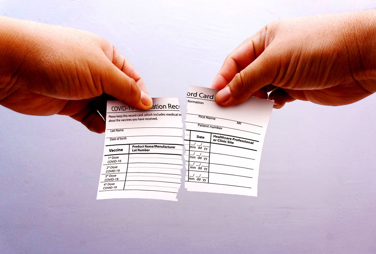 Ripping vaccination record card (Photo illustration by Salon/Getty Images)