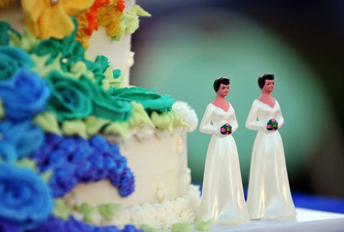 Wedding cake decorated with figures of two brides (GABRIEL BOUYS/AFP via Getty Images)