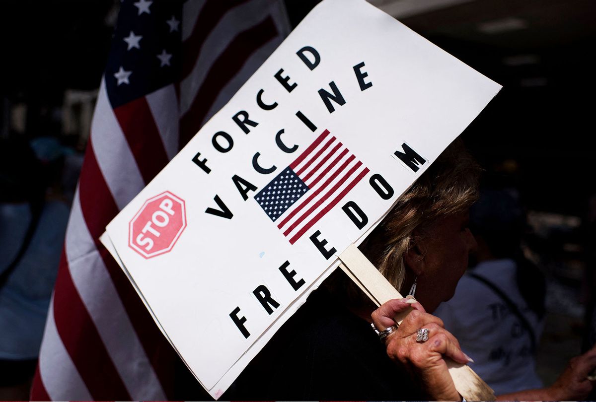 Anti-vaccine rally protesters hold signs outside of Houston Methodist Hospital in Houston, Texas, on June 26, 2021. (MARK FELIX/AFP /AFP via Getty Images)