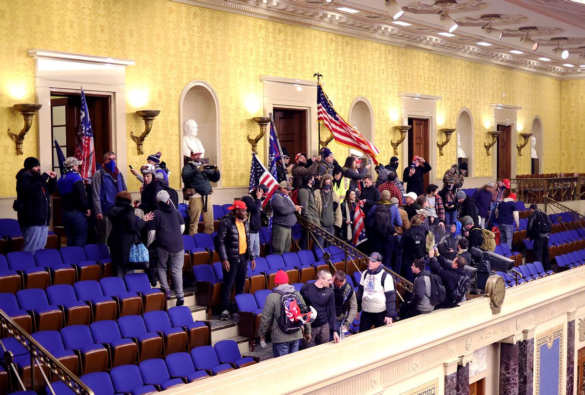 Protesters enter the Senate Chamber on January 06, 2021 in Washington, DC. Congress held a joint session today to ratify President-elect Joe Biden's 306-232 Electoral College win over President Donald Trump. Pro-Trump protesters have entered the U.S. Capitol building after mass demonstrations in the nation's capital. (Win McNamee/Getty Images)