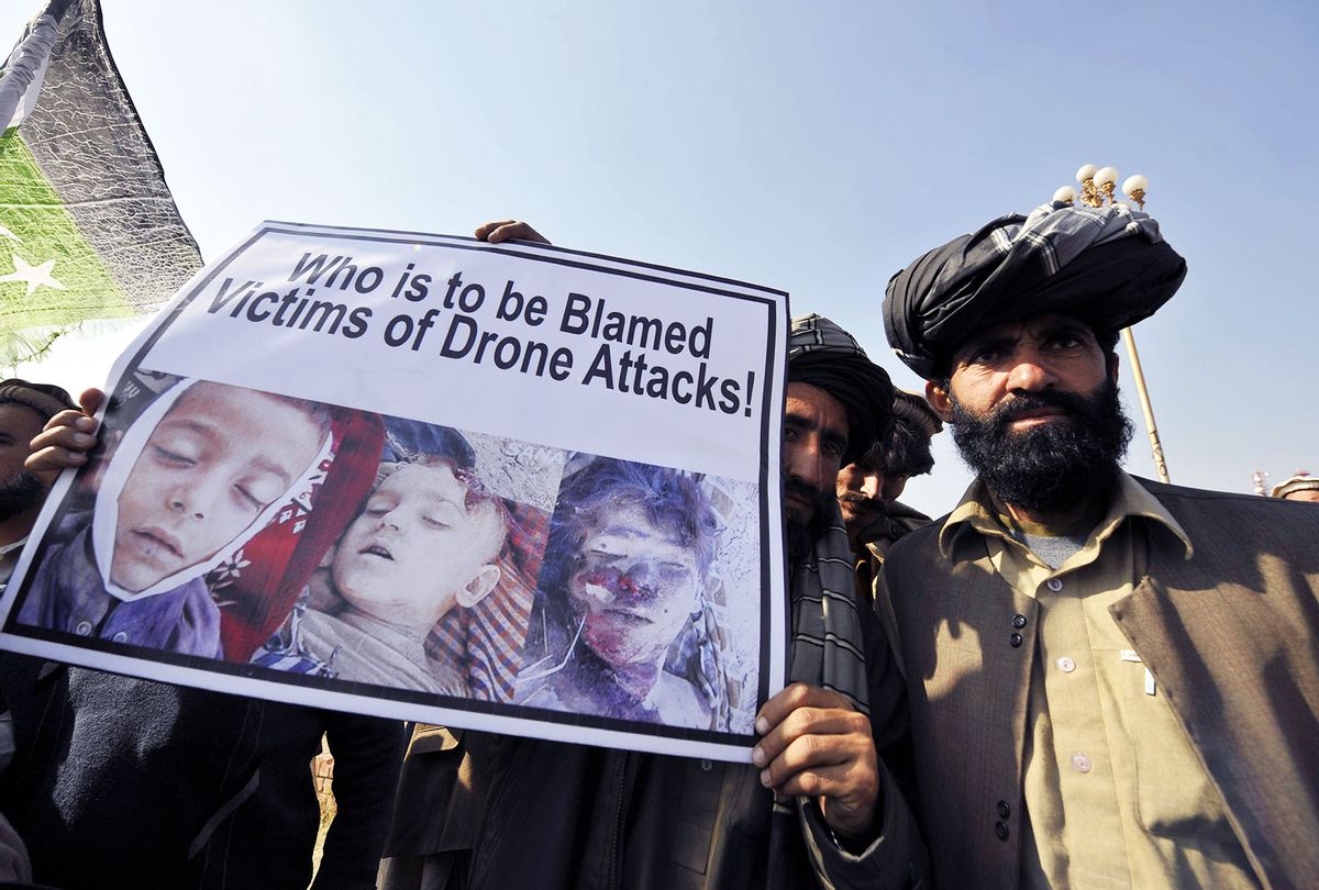 Pakistani tribesmen hold up a placard of alleged drone strike victims during a protest in Islamabad on February 25, 2012, against the US drone attacks in the Pakistani tribal region. The protesters demanded an immediate end to drone attacks and compensation for those who lost relatives or property, as well as condemning this week's burning of Korans at a US-run base in neighbouring Afghanistan. (AAMIR QURESHI/AFP via Getty Images)