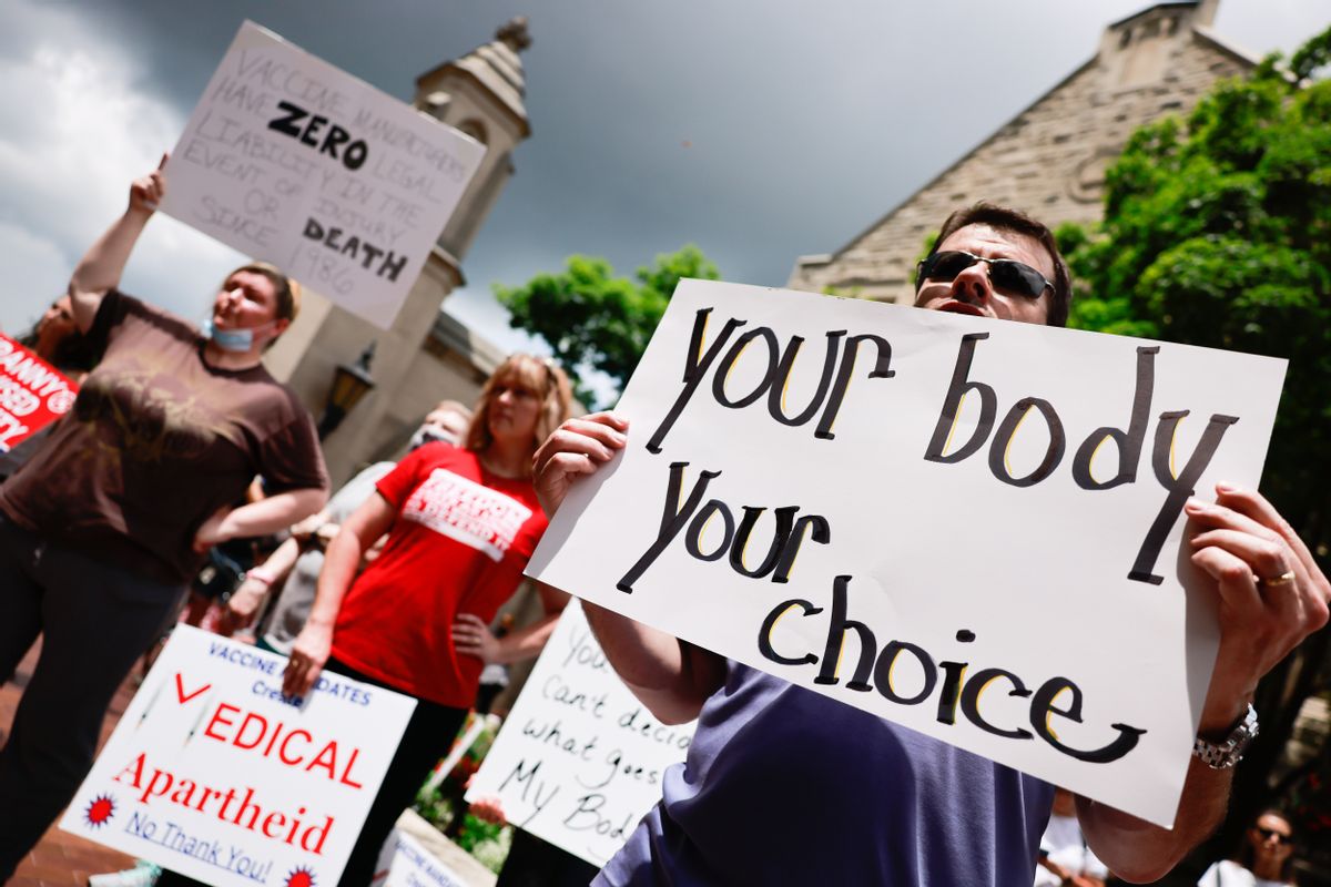 Protesters holding placards gather at Indiana University's Sample Gates during an anti-vaccine demonstration. (Jeremy Hogan/SOPA Images/LightRocket via Getty Images)