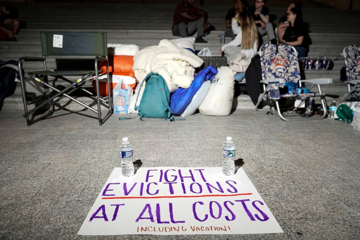 A sign calling for an extension to a federal eviction moratorium sits near Rep. Cori Bush (D-MO) as she spends the night outside the U.S. Capitol on July 31, 2021. (Getty Images)