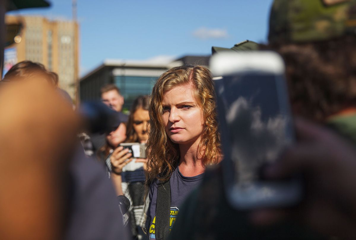 Kaitlin Bennett, a a squad of Three Precenter Milita members and a wall of police, tried to debate counter protesters. (Shay Horse/NurPhoto via Getty Images)