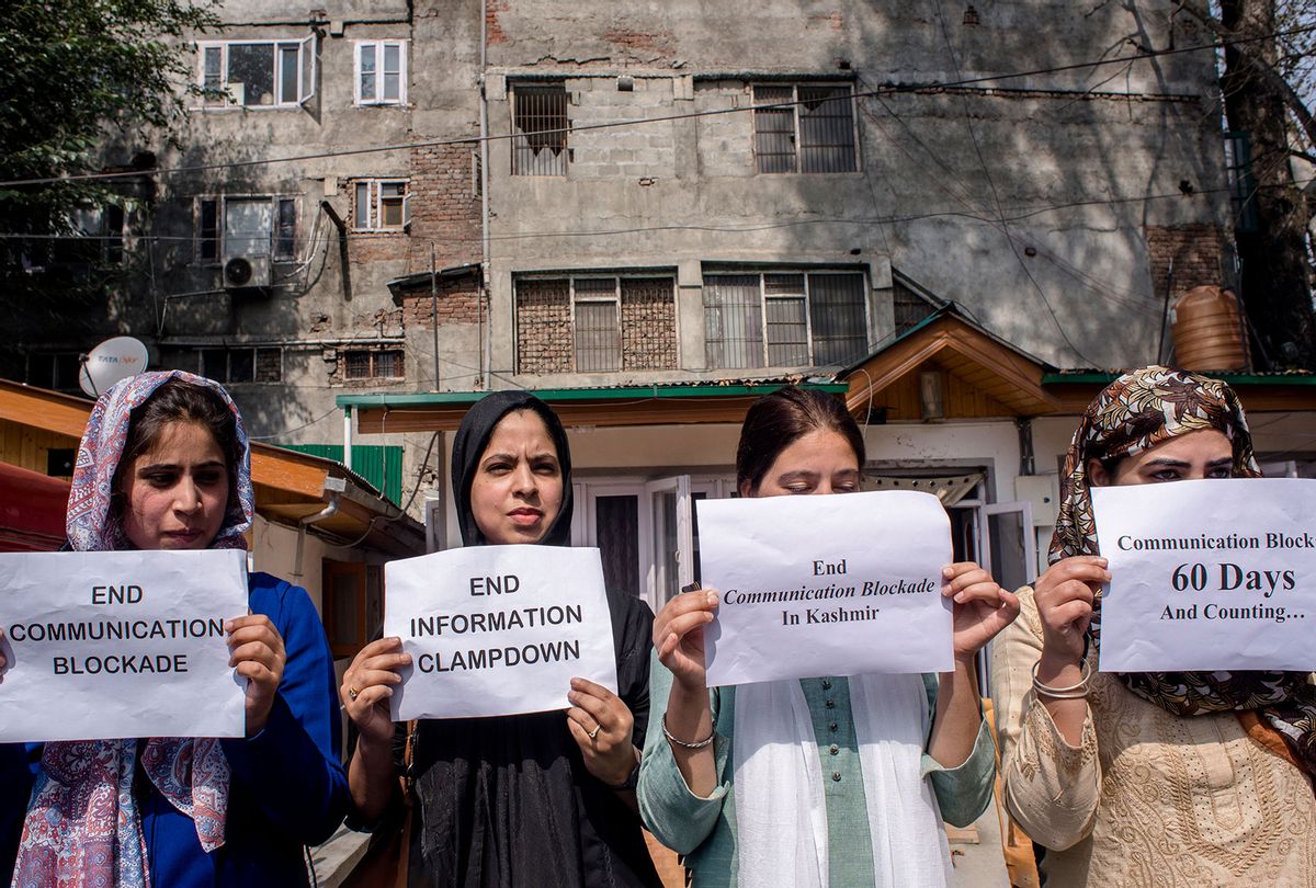 Kashmiri women journalists hold placards as they protest against the continued communication blockade by the Indian authorities after the revocation of special status of Kashmir on Oct. 3, 2019 in Srinagar. (Yawar Nazir/Getty Images)