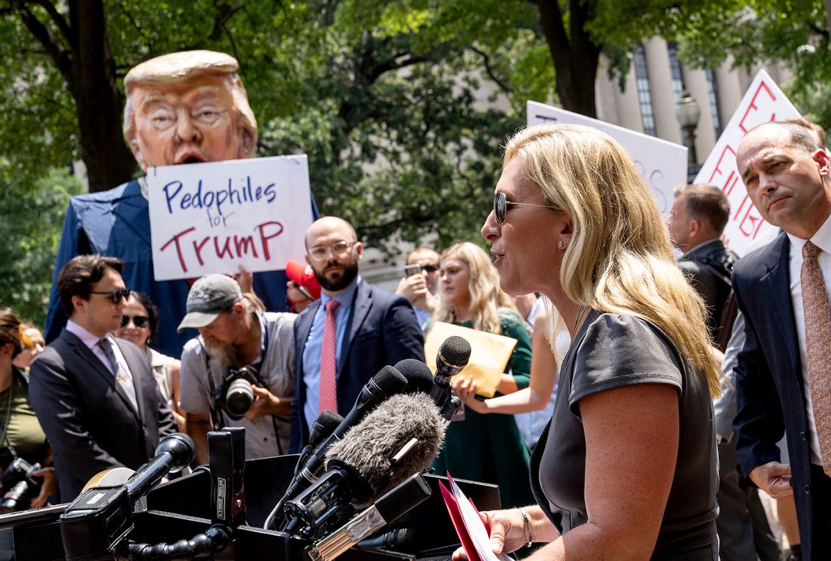 Protestors hold an effigy of former President Donald Trump as Rep. Marjorie Taylor Greene (R-GA) speaks during a news conference outside the U.S. Department of Justice on July 27, 2021 in Washington, DC. The group of far-right conservatives held a news conference to demand answers from Attorney General Merrick Garland on the status of January 6 prisoners. (Drew Angerer/Getty Images)