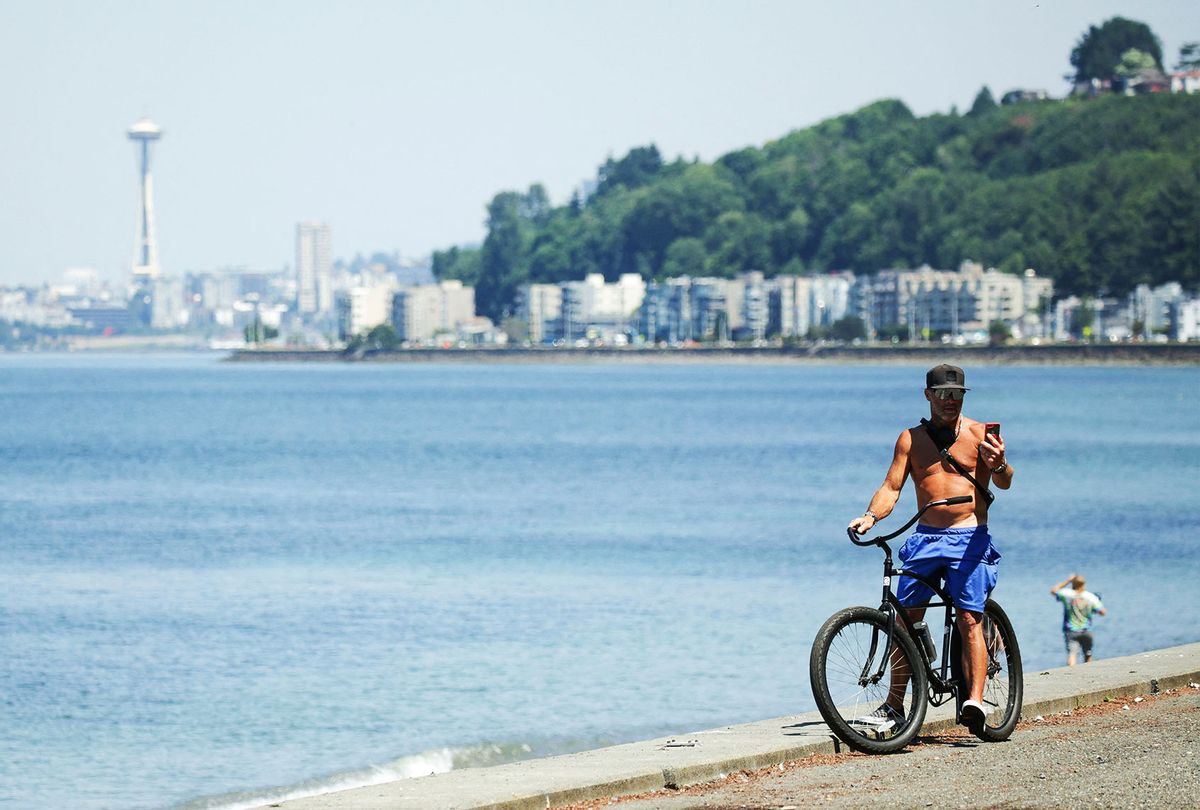 A bike rider is pictured as an excessive heat warning remains in effect a day after record-breaking temperatures from a historic heatwave throughout the region in Seattle, Washington on June 29, 2021. (JASON REDMOND/AFP via Getty Images)