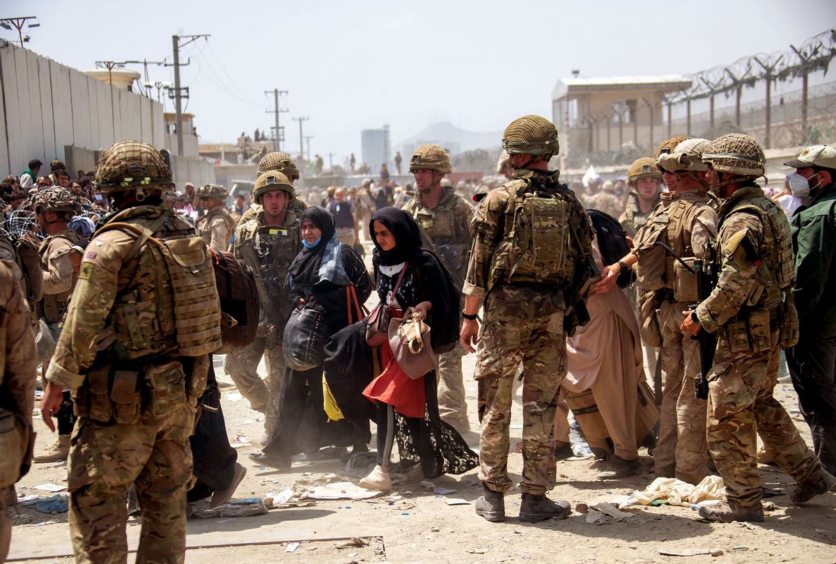 In this handout image provided by the Ministry of Defence, the British armed forces work with the U.S. military to evacuate eligible civilians and their families out of the country on August 21, 2021 in Kabul, Afghanistan. (MoD Crown Copyright via Getty Images)