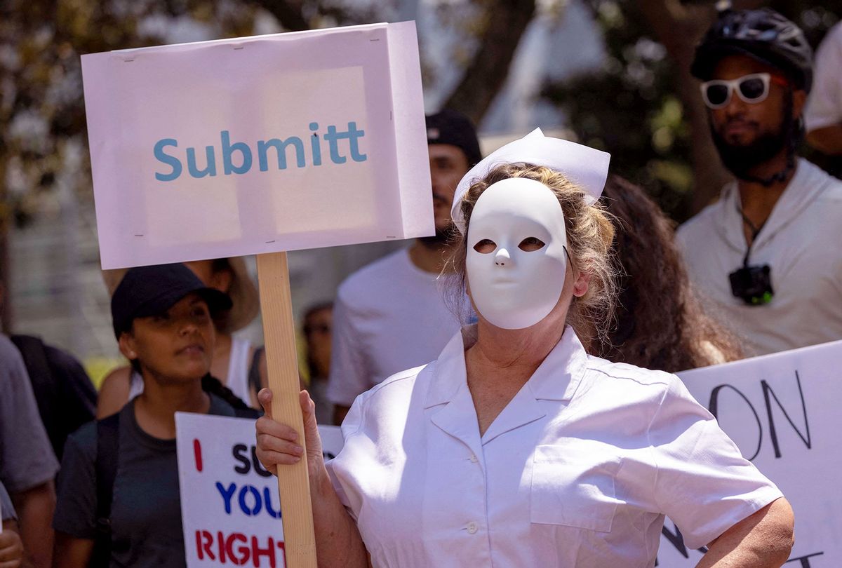 A protester dressed as a scary nurse holds a mispelled sign that reads "Submitt" at an anti-vaccination protest rally near City Hall, following the Los Angeles City Council's vote earlier this week on drafting an ordinance requiring proof of vaccination to enter many indoor public spaces in Los Angeles, on August 14, 2021. (DAVID MCNEW/AFP via Getty Images)