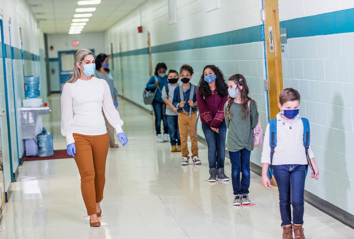 Students and teacher in school during COVID-19 pandemic, wearing masks (Getty Images)