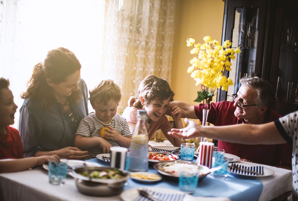 Family enjoying dinner. (Getty Images/Milos Stankovic)