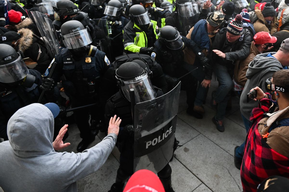 Riot police push back a crowd of supporters of US President Donald Trump after they stormed the Capitol building on January 6, 2021. (ROBERTO SCHMIDT/AFP via Getty Images)