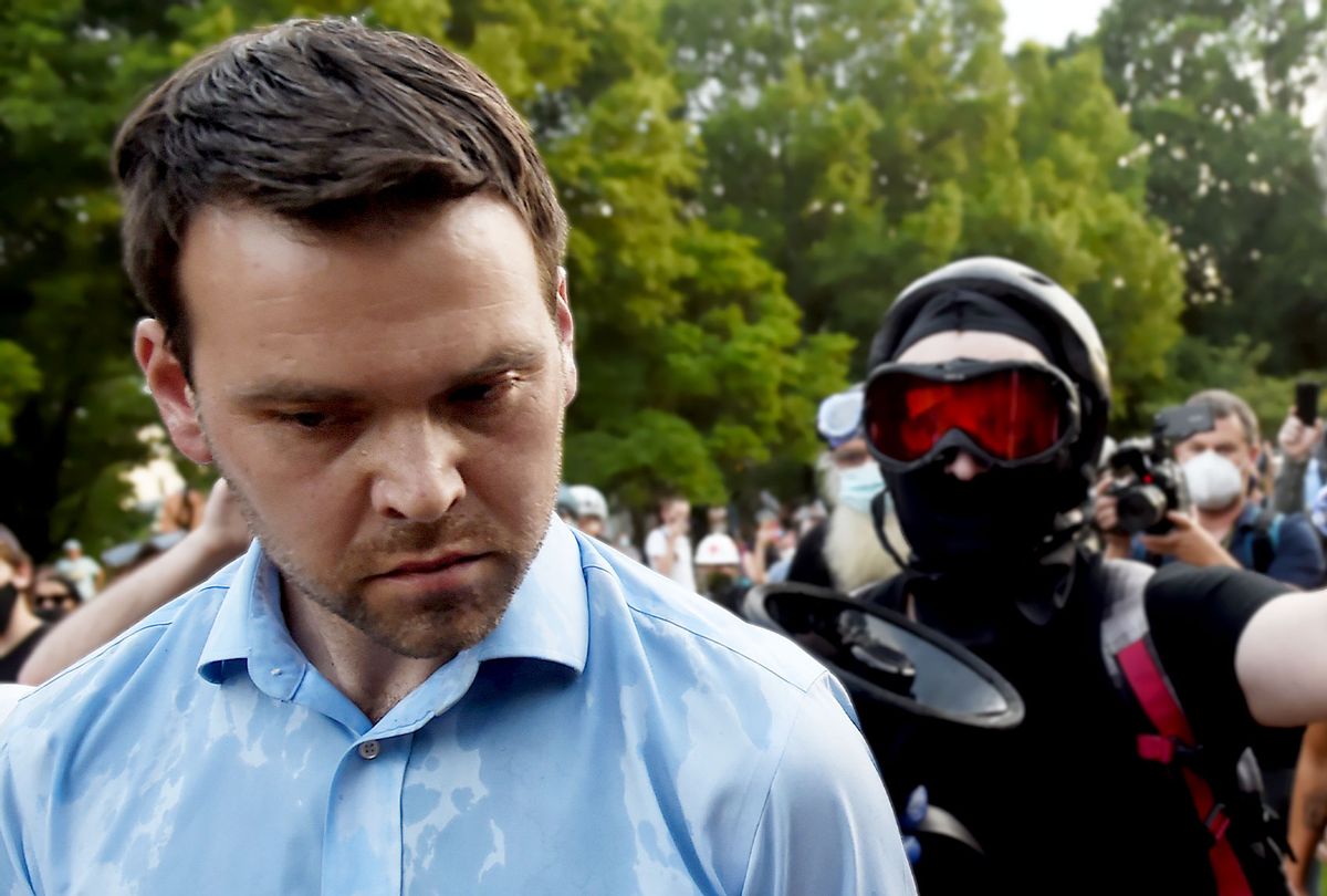 Conservative activist and Trump supporter Jack Posobiec (L) is escorted out of the Lincoln Park by anti-racism protesters near the Emancipation Memorial in Washington, DC on June 26, 2020. (OLIVIER DOULIERY/AFP via Getty Images)