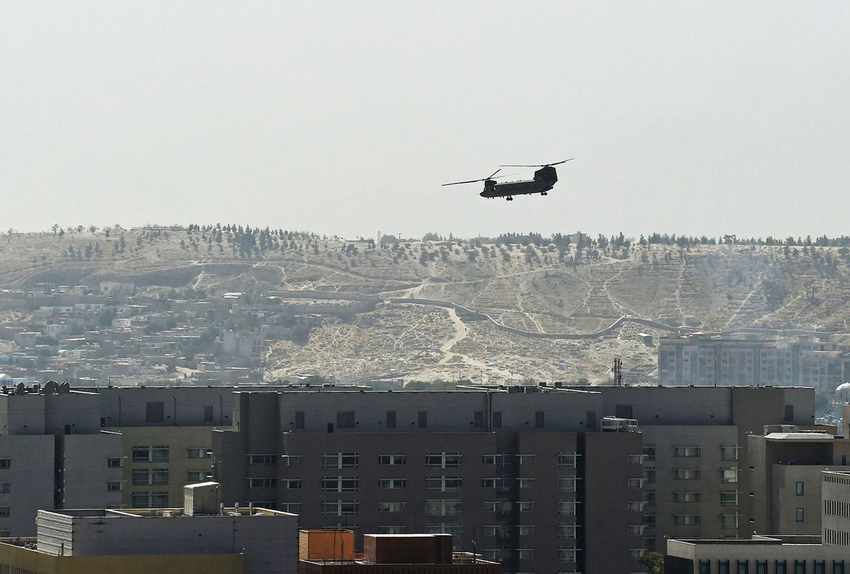 A U.S. Chinook military helicopter flies above the US embassy in Kabul on August 15, 2021. Several hundred employees of the US embassy in Kabul have been evacuated from Afghanistan, a US defense official said on August 15, 2021, as the Taliban entered the capital. (WAKIL KOHSAR/AFP via Getty Images)